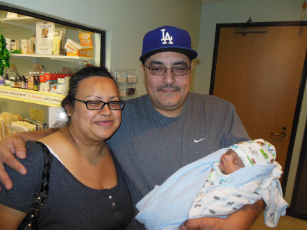 Man and Woman holding their bundled-up baby